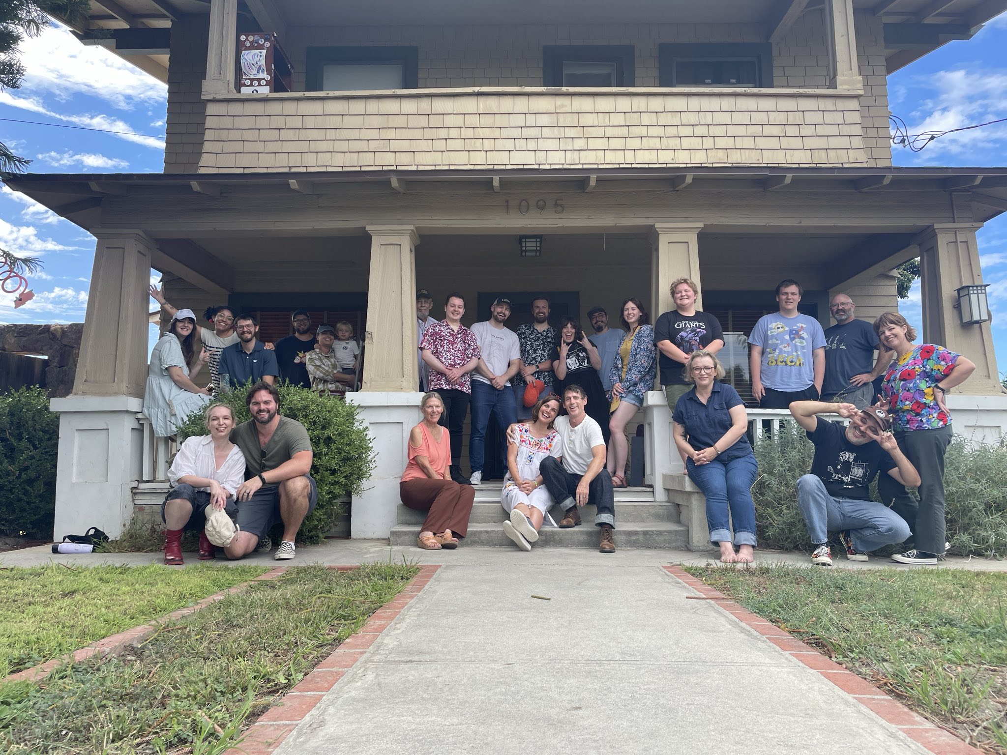 image of family and friends gathered in front of the house.