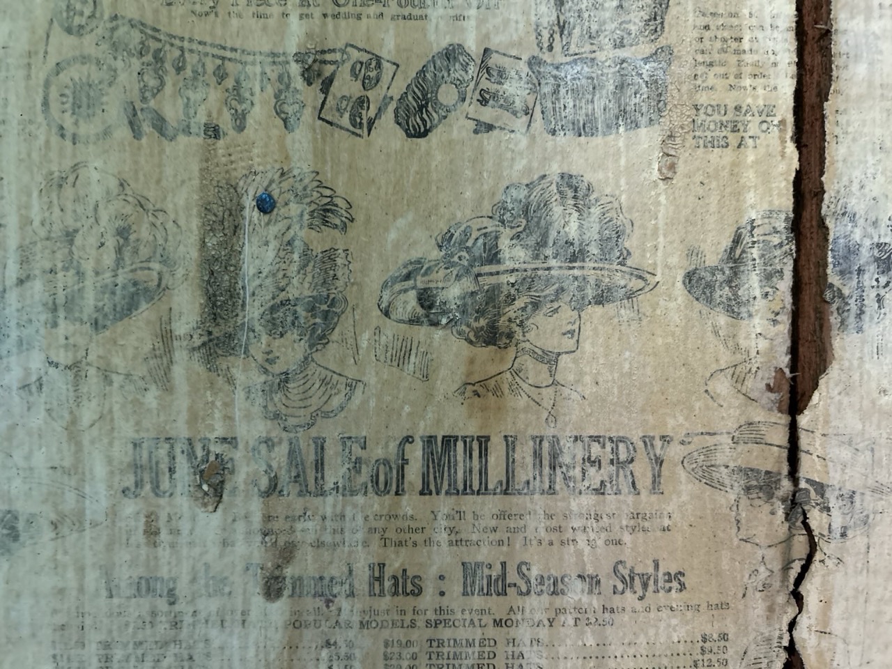image of a wall with some old newspapers plastered on.